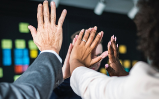 Hands doing a high five to celebrate achievement