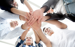 Low Angle View of Business Team Standing with their Hands Piled Up Together