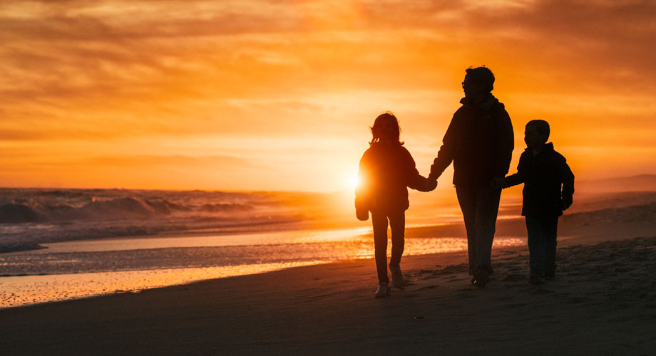 Silhouette of Family on Beach at Sunset