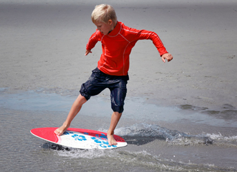A boy on a skimboard